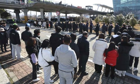 Mourners wait to pay tribute to the victims of a plane fire at a memorial altar at Muan International Airport in Muan, South Korea, Wednesday,Jan 1,2025 (AP)&nbsp;