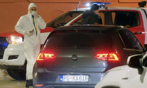 Police investigators work at the site of a shooting in Cetinje, 36 kilometers (22 miles) west of Podogrica, Montenegro (AP)