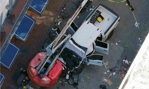 A black flag with white lettering lies on the ground rolled up behind a pickup truck that a man drove into a crowd on Bourbon street in New Orleans, killing and injuring a number of people. early Wednesday morning, Jan 1, 2025. (AP)