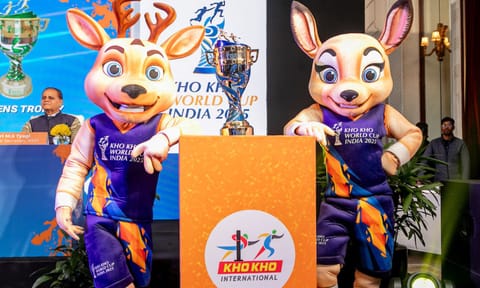 The official mascots of the Kho Kho World Cup pose with the trophy&nbsp;