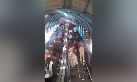 People climbing down the out-of-order escalator