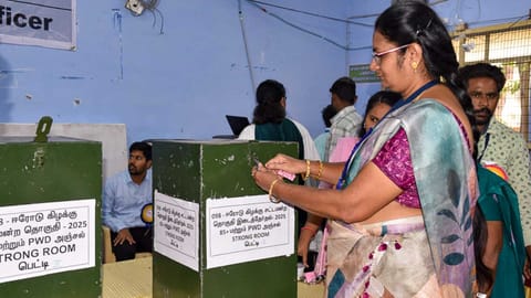 Polling officials check postal votes at a counting center during the counting of votes for the Erode East Assembly by-election (PTI)