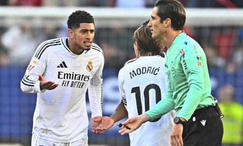 Real Madrid's Jude Bellingham, left, speaks with Real Madrid's Luka Modric after being shown a red card by the referee during a Spanish La Liga soccer match (AP)