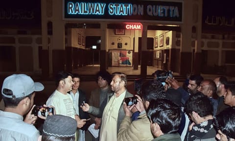 Relatives of passengers of a train, which is attacked by insurgents, gather to get information about passengers from special counter at a railway station in Quetta, Pakistan (AP)