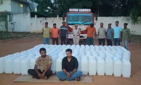 The lorry drivers with the seized rectified spirit on Wednesday&nbsp;