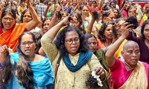 Accredited Social Health Activist (ASHA) workers cut their hair during a protest, demanding an increase in their honorarium, in Thiruvananthapuram (PTI)