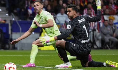 Barcelona's Ferran Torres scores by Atletico Madrid's goalkeeper Juan Musso during the Spanish Copa del Rey semifinal second leg soccer match between Atletico Madrid and Barcelonaat the in Madrid (AP)