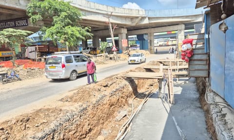 A man walking by the open construction of the stormwater drain in Perungalathur’s&nbsp; Sathananthapuram - Nedungundram Road