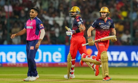 Virat Kohli and Phil Salt run between the wickets as Rajasthan Royals' Tushar Deshpande looks on during the Indian Premier League (IPL) 2025 cricket match between RCB and RR, at M Chinnaswamy stadium in Bengaluru (PTI)&nbsp;