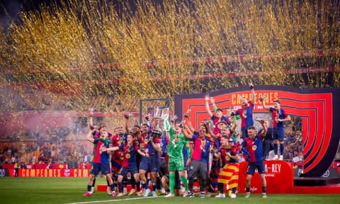 Barcelona players celebrate with the trophy after winning the Spanish Copa del Rey final soccer match between Barcelona and Real Madrid at Estadio de La Cartuja stadium in Seville (AP)