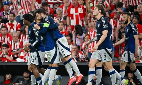 Manchester United players celebrate after scoring a goal