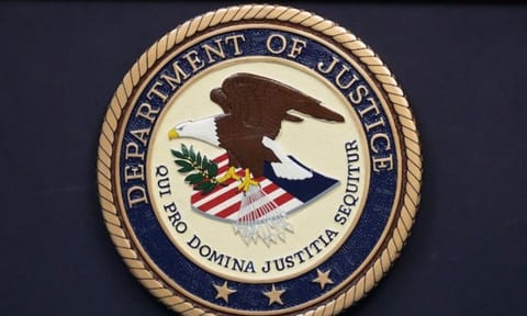 The Department of Justice seal is seen during a press conference (AP)&nbsp;