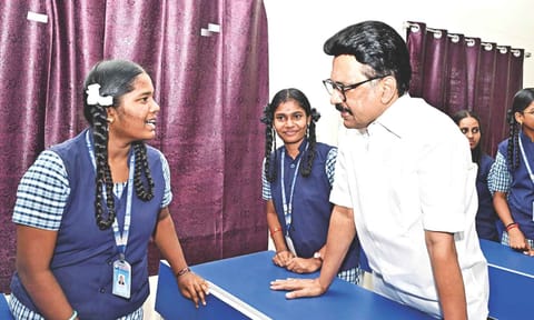 Chief Minister MK Stalin interacting with a student at the model school in Tiruchy on Thursday&nbsp;