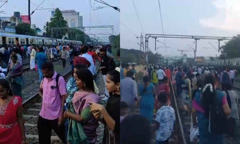 Following the chaos, several passengers walk along the tracks toward bus stops on the GST Road, on Sunday
