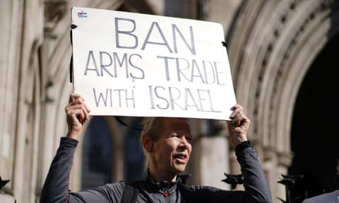 Demonstrators gather outside royal courts of justice in London (AP)