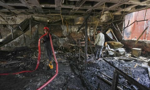 A firefighter at the site after a fire broke out in the library of Guru Gobind Singh College of Commerce, in northwest Delhi's Pitampura, Thursday, May 15, 2025 (PTI)&nbsp;