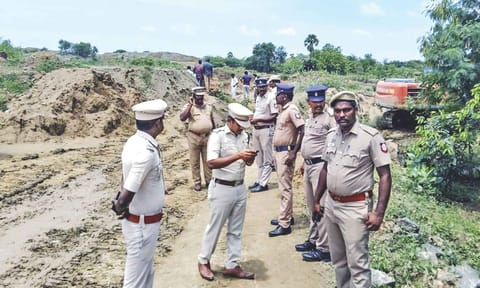 Police personnel stand near the stone quarry in Mallakottai&nbsp;