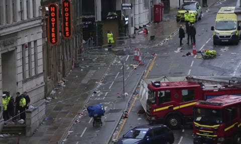 Fans leave as Police and emergency personnel deal with an incident after a car collided with pedestrians near the Liver Building during the Premier League winners parade in&nbsp;Liverpool&nbsp;(AP)