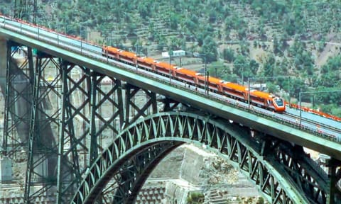 Reasi: Vande Bharat train, flagged off by Prime Minister Narendra Modi, crosses the Chenab rail bridge, in Reasi district of J&amp;K, Friday (PTI)