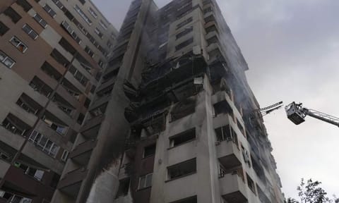 A firefighter stands on a crane at the scene of an explosion at a residence compound after Israeli attacks in Tehran, Friday, June 13, 2025 (PTI)&nbsp;