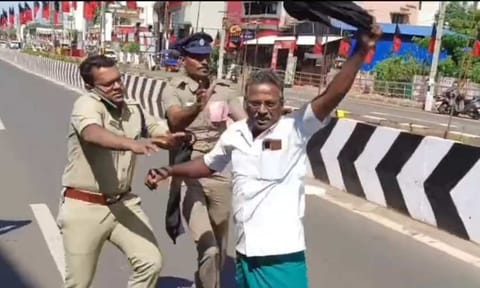 Police personnel forcibly removing farmers who were trying to wave a black flag at the Chief Minister in Thanjavur on Monday&nbsp;