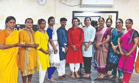 Shanmugasundaram (red kurta) with his students
