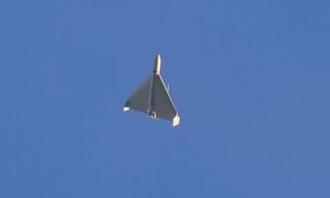 An Iranian Shahed exploding drone launched by Russia flies through the sky seconds before it struck buildings in Kyiv (AP)