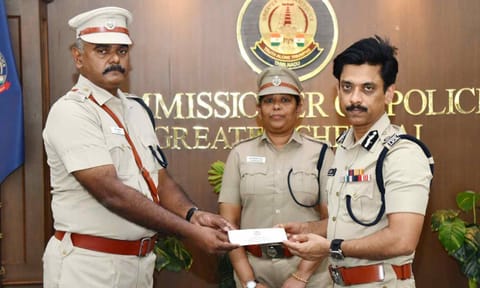ACP (Vepery) R Kannan receives a certificate of appreciation from Commissioner A Arun. Also seen is DCP (Kilpauk) J Jareena Begam&nbsp;&nbsp;