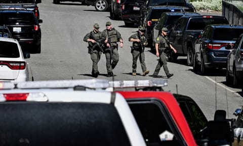 Police and fire crews respond to a shooting and fire on Canfield Mountain (AP)