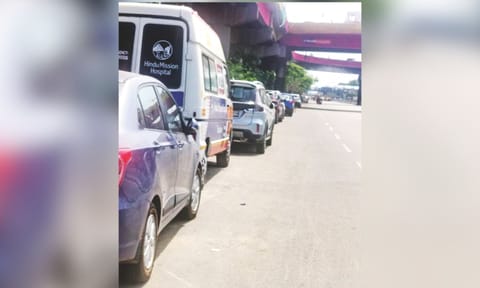 Four-wheelers parked on the side of the GST Road