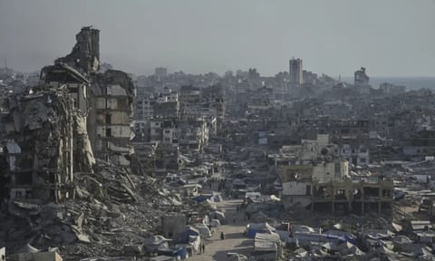 Tents sheltering displaced Palestinians are seen amid war-damaged infrastructure in Gaza City (AP Photo)