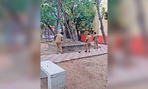 Workers cleaning the children’s park in MMDA Nagar on Wednesday
