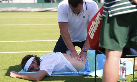 Stefanos Tsitsipas of Greece receives treatment during his first round men's single match against Valentine Royer of France at the Wimbledon Tennis Championships in London, Monday, June 30, 2025 (AP)&nbsp;