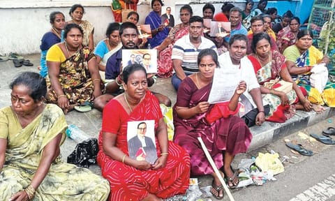 Workers from the National Urban Livelihoods Mission sitting in protest outside Ripon Building on Friday