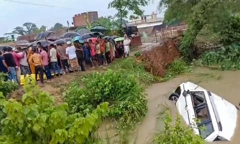 People stand near the Saryu canal after an SUV fell in the canal leaving at least 11 people dead and four others critically injured, in Gonda district, Uttar Pradesh, Sunday, Aug. 3, 2025. (PTI)&nbsp;