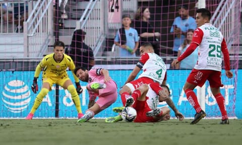 &nbsp;Lionel Messi tackled by defenders during the match