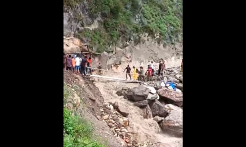 People move across an affected area after a flash flood following a cloudburst in Chashoti area of Kishtwar, Thursday (PTI)