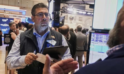 Trader Michael Capolino left, works on the floor of the New York Stock Exchange, Monday, Aug. 18, 2025 (AP)&nbsp;