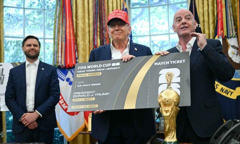 FIFA President Gianni Infantino presents Donald Trump with a final match ticket at the Oval Office
