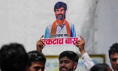 An agitator holds a cutout of activist Manoj Jarange Patil during his indefinite hunger strike demanding reservation for the Maratha community in Mumbai (PTI)