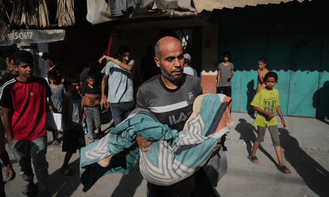 A Palestinian man carries the body of Hassan Nasr, 12, who was killed by an Israeli military strike in Zawaida, central Gaza Strip, Thursday, Sept. 25, 2025. AP/PTI