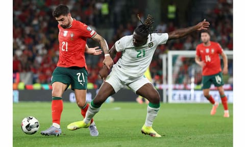 Ruben Neves (L) and defender Festy Ebosele fight for the ball during the match&nbsp;