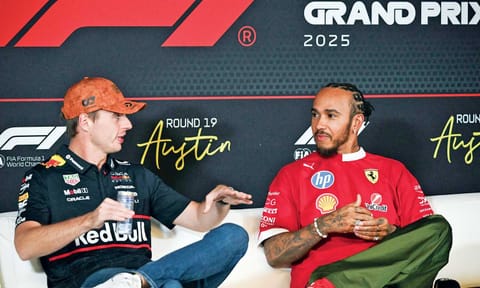 Max Verstappen (L) and Lewis Hamilton (R) speak during a press conference