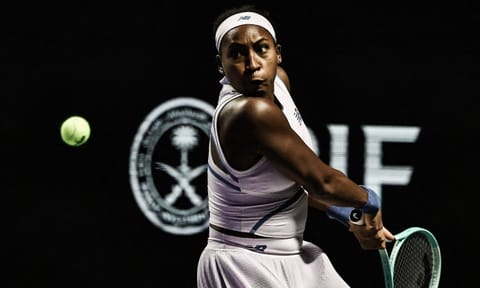 Coco Gauff returns a shot during the match