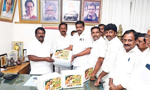 Madurai party head Karthekeyan handing over petitions with signatures against electoral malpractices to Selvaperunthagai
