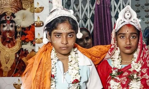 The 'wedding' of same-sex couple Riya Sardar and Rakhi Naskar being solemnised by the residents of Kultali village in West Bengal's Sundarbans (PTI)&nbsp;