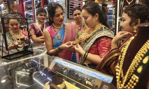 Women try gold jewellery at a shop on the 'Vijayadashami' festival, in Mumbai (PTI)&nbsp;