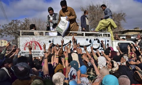 File Image of People jostle each other to buy subsidised sacks of wheat flour in Quetta, Pakistan (AP)&nbsp;