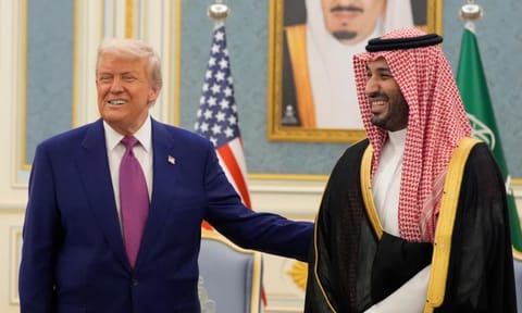 President Donald Trump and Saudi Crown Prince Mohammed bin Salman gesture as they meet delegations at the Royal Palace in Riyadh, Saudi Arabia (AP)