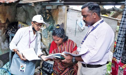 Booth-level officer (BLO) distributing the SIR forms to the public.&nbsp;